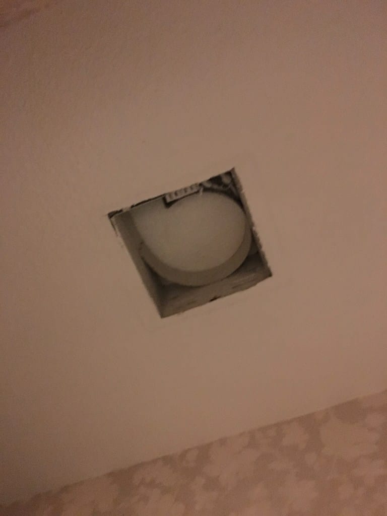 Down to a hole in the wall.