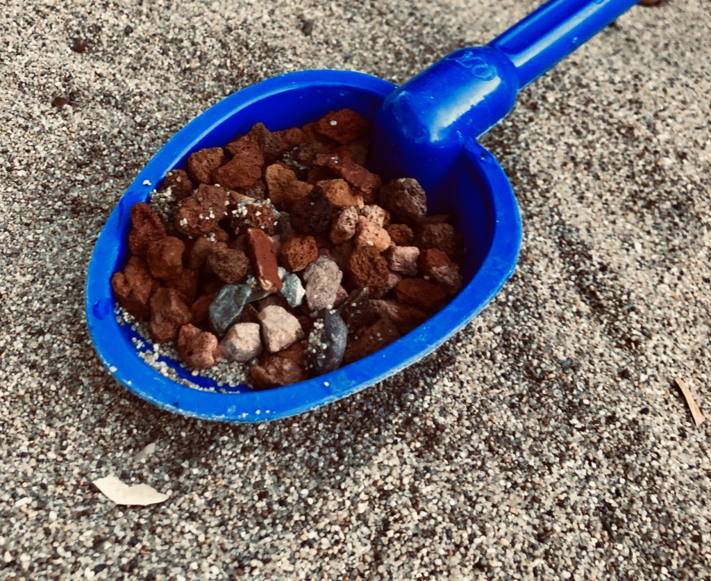 A shovel-full of little stones in the sand